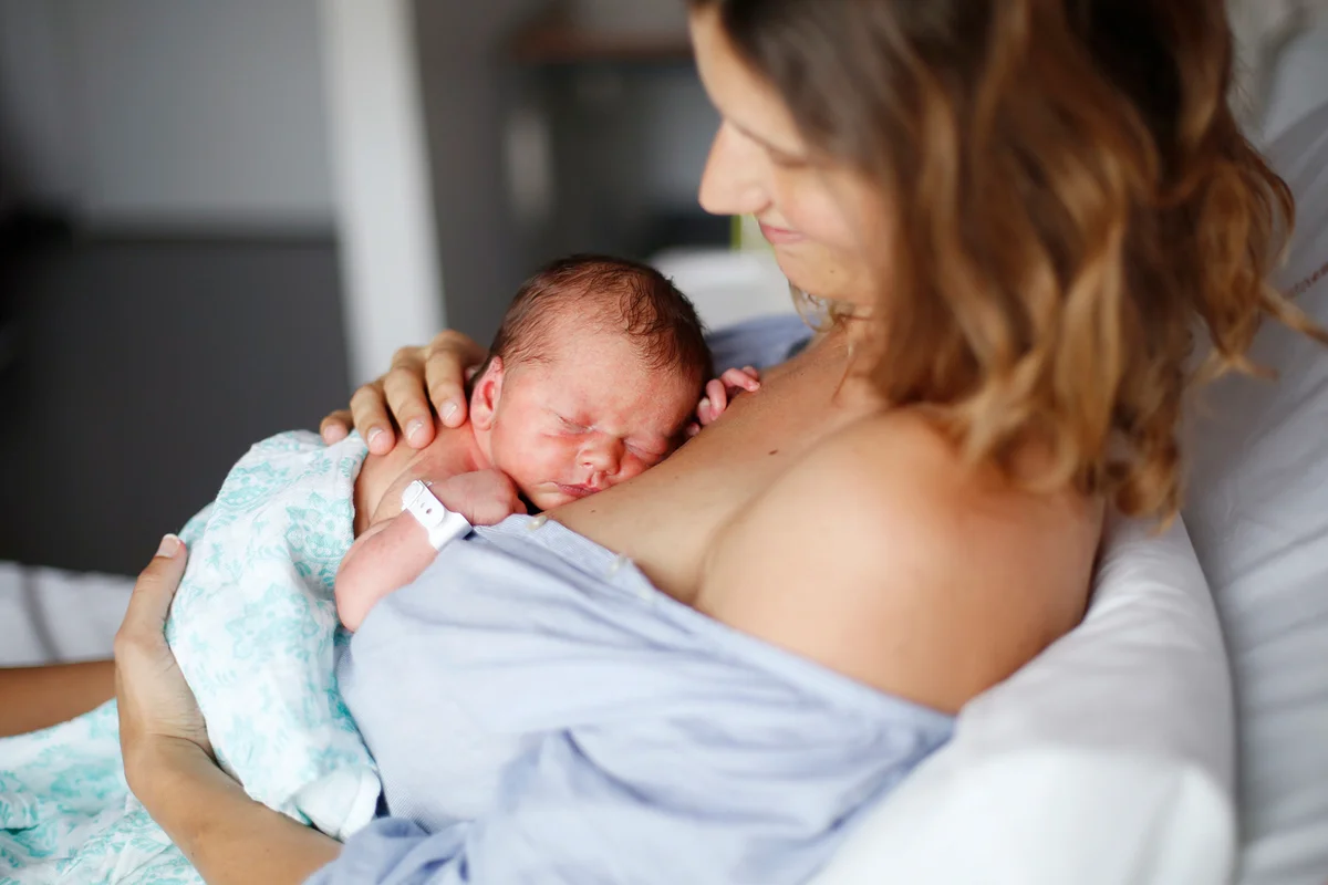 A newborn and his mother at maternity ward