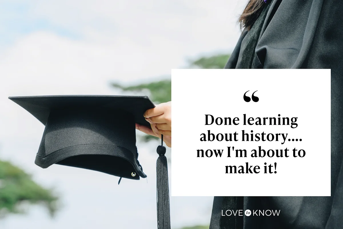 Student wearing graduation gown and holding a graduation cap