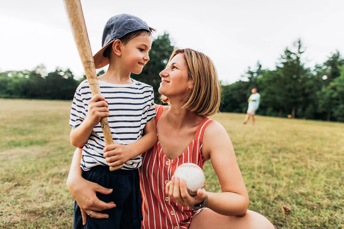 little boy, baseball player, who needed some cheering and courage from his mother