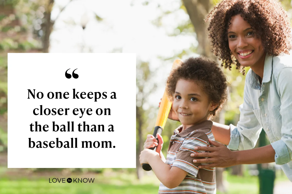 Mother and son playing baseball in park