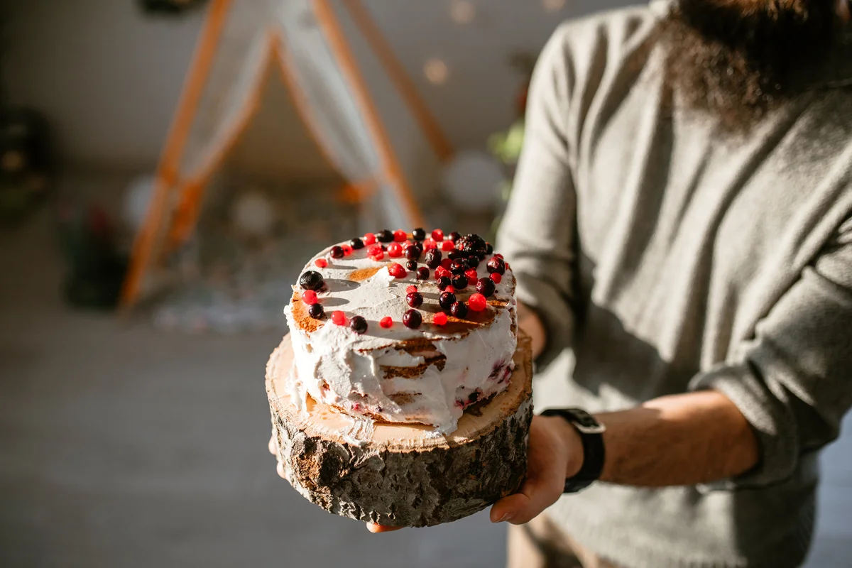 Boho birthday cake with rustic elements and berries on top