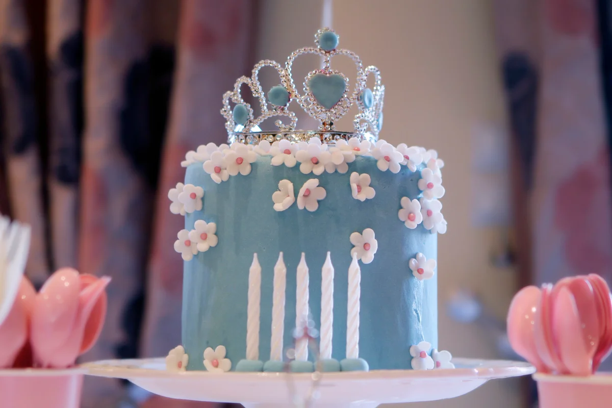 Blue birthday cake topped with blue tiara