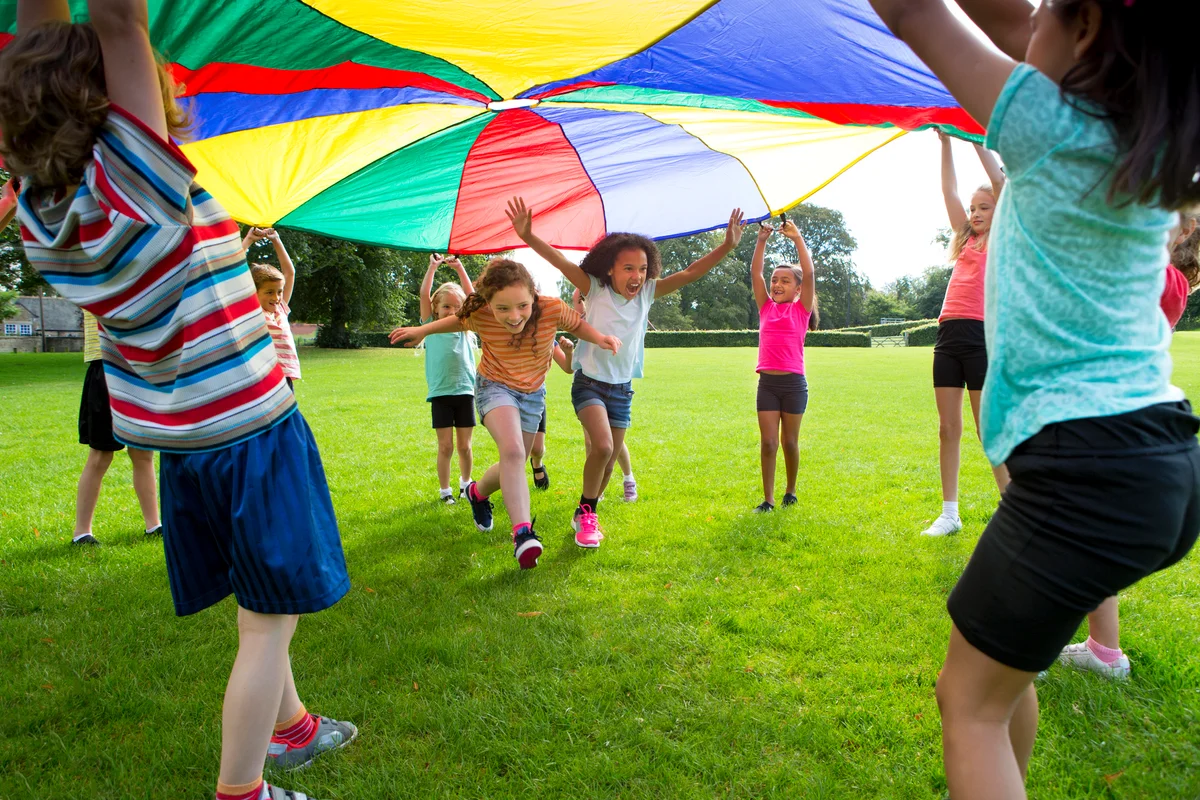 kids playing with a parachute in the park