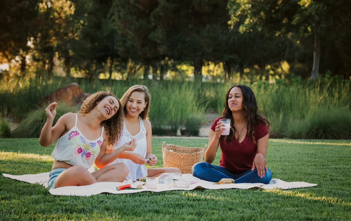 teen girls having a picnic at the park