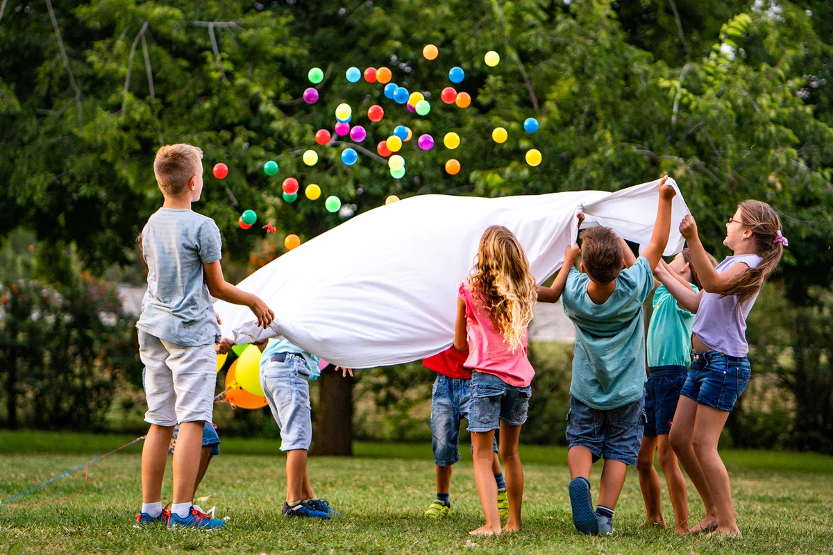 children are playing, throwing balls at a birthday party
