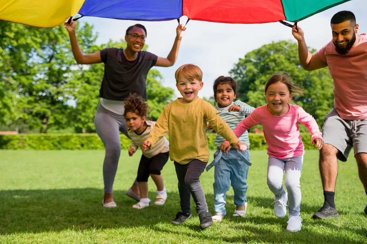 Children playing with a parachute at a preschool