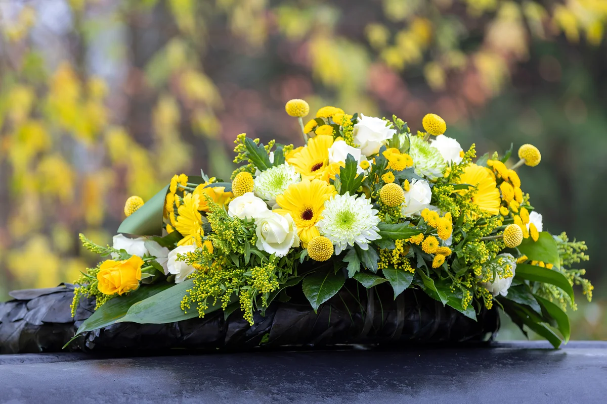 Funeral wreath with yellow and white flowers