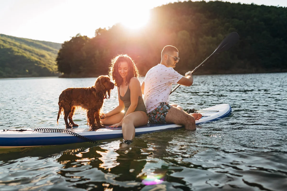 Loving couple rowing on the lake during a sunny day