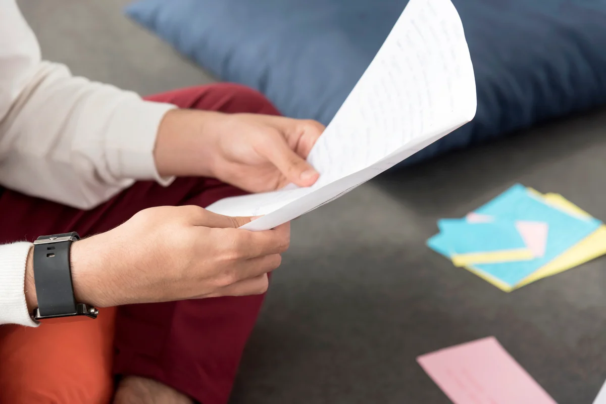 Man reading the letter sitting on the floor