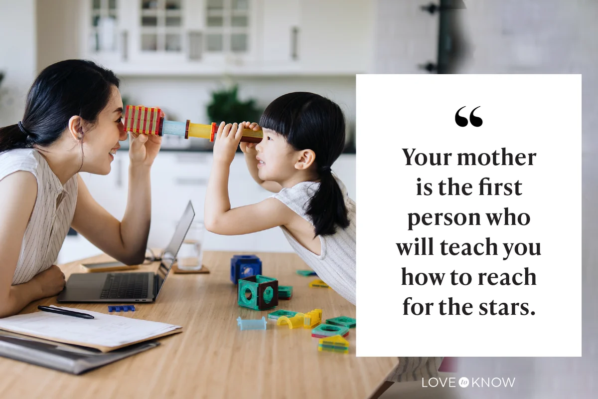 mother working from home while little daughter playing with her
