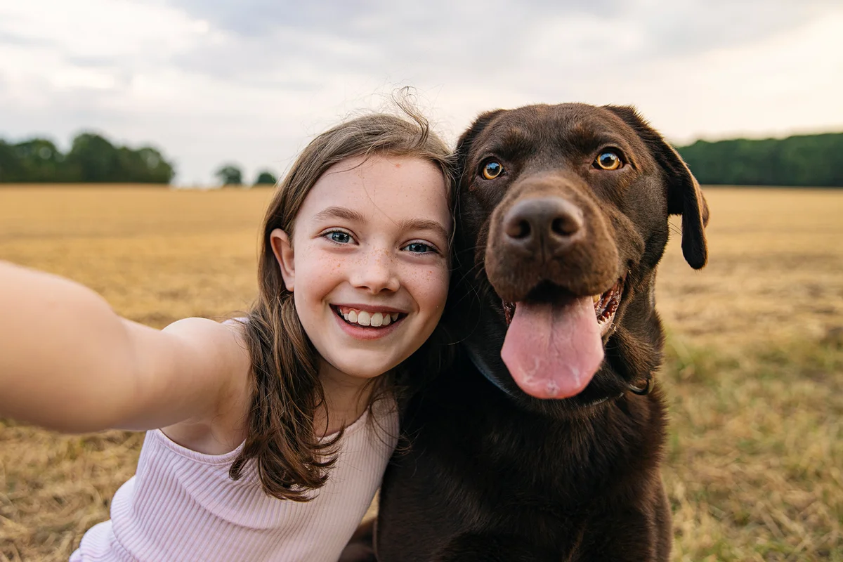 Girl taking a selfie with her pet dog