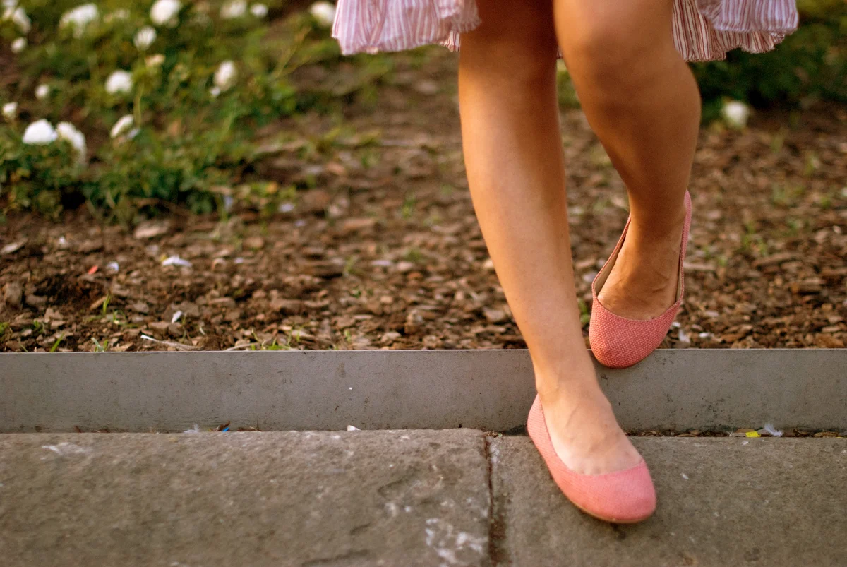 Woman wearing pink flats outside