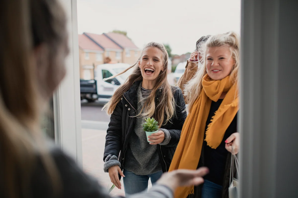Woman greeting her friends for anything but cups party