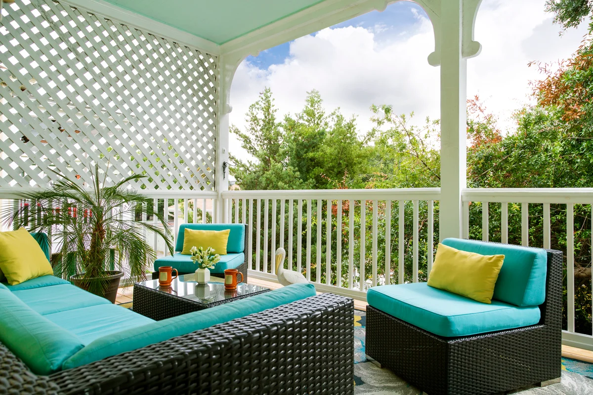 Large porch with outdoor furniture and decorative lattice