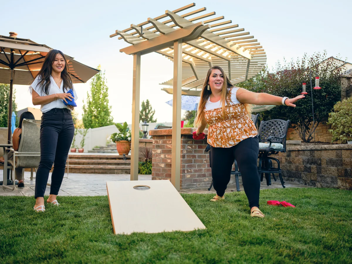 two women playing cornhole