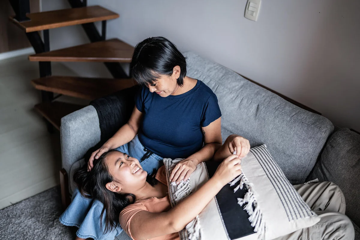 Mother taking to daughter at home