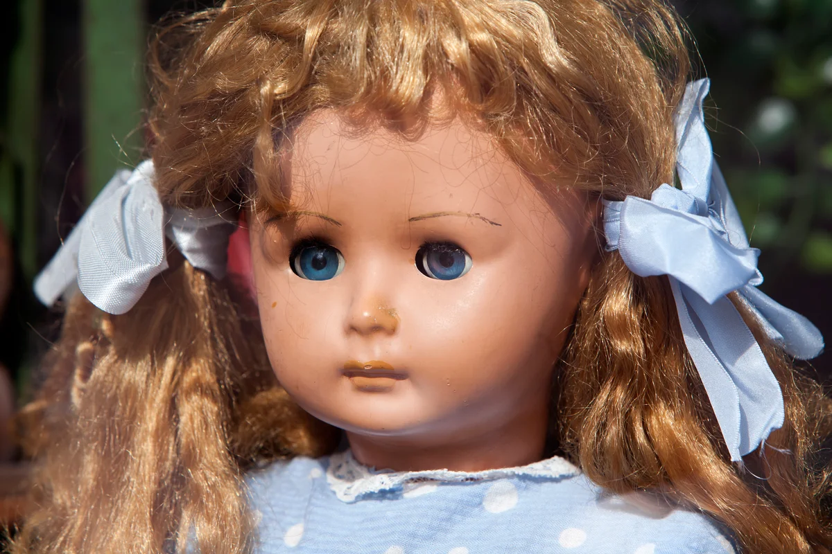 Doll wearing blue dress with strawberry blonde pigtails