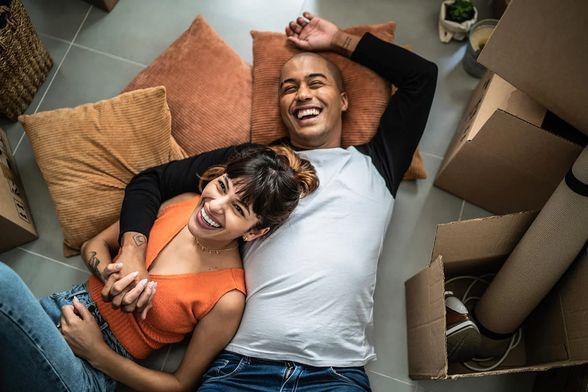 Happy young couple lying on the floor