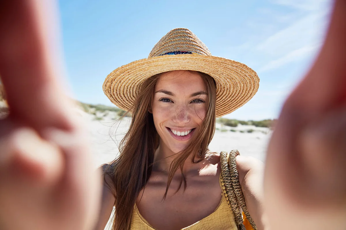 Portrait of smiling young woman on the beach