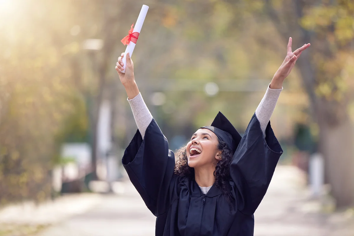 Shot of a young woman cheering on graduation day