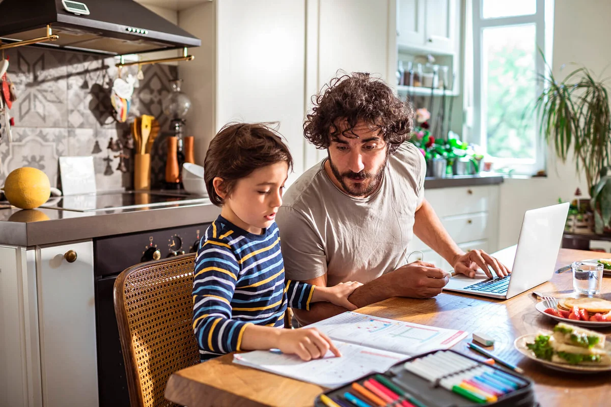 Father helping his son with schoolwork