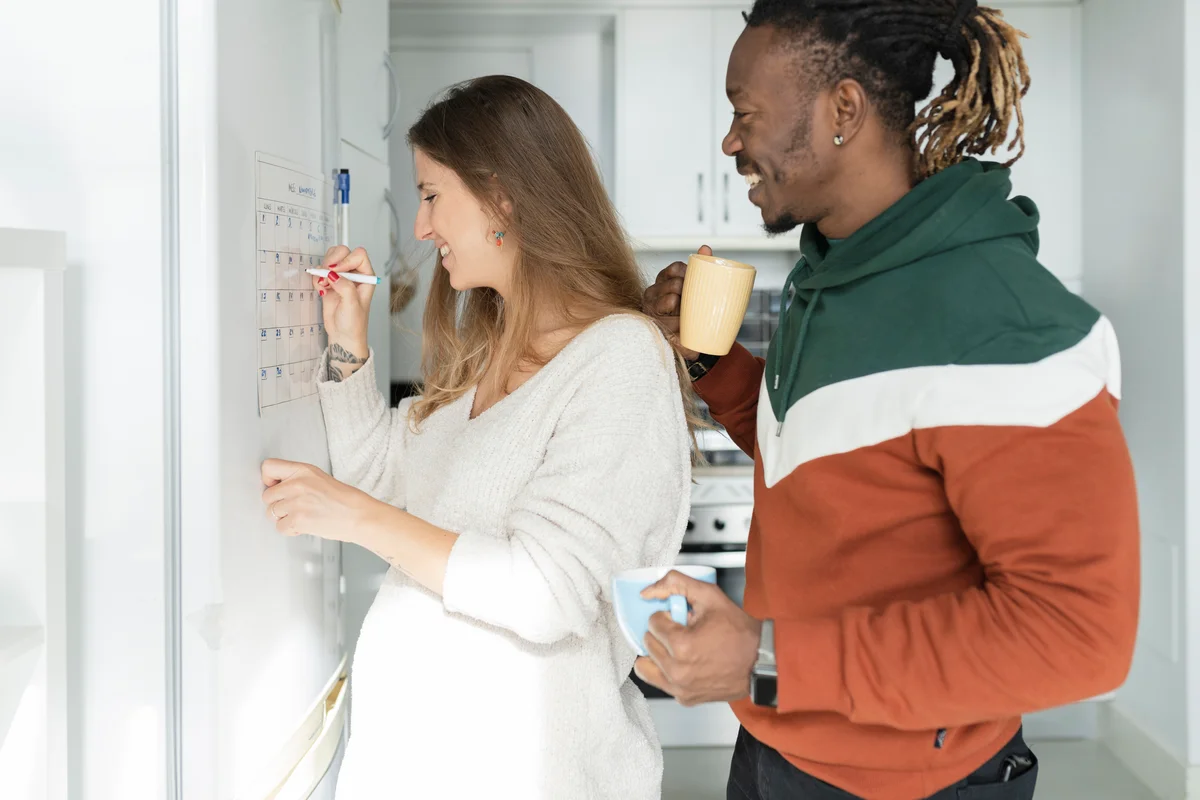 pregnant couple looking at calendar