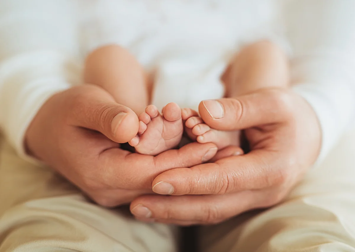 father holding newborn