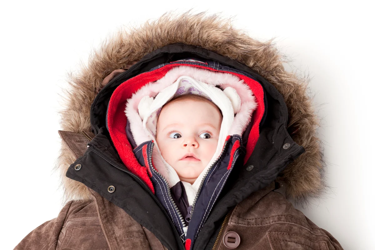 baby wearing multiple jackets