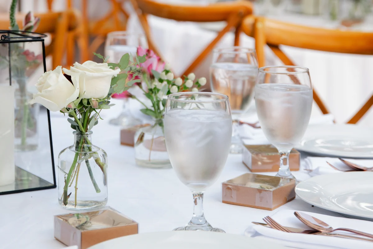 Backyard wedding reception with glasses of water