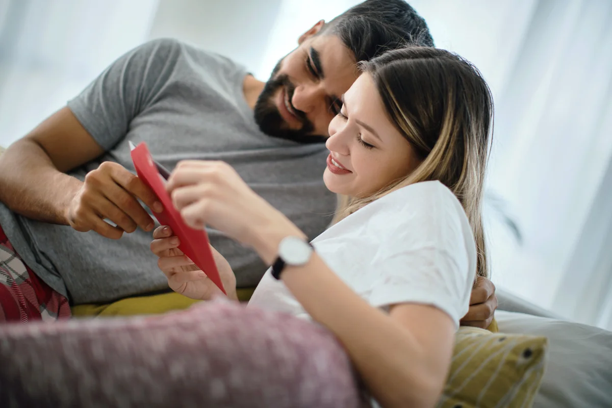 Couple reading wedding invitation