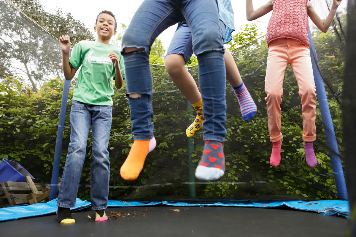 Children jumping on trampoline