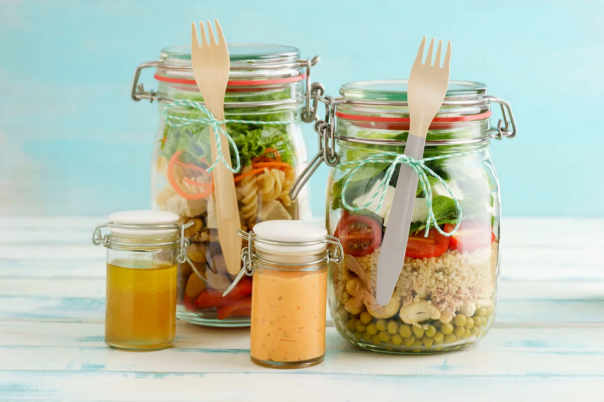 Preserving jars of mixed salads and jars of dressings