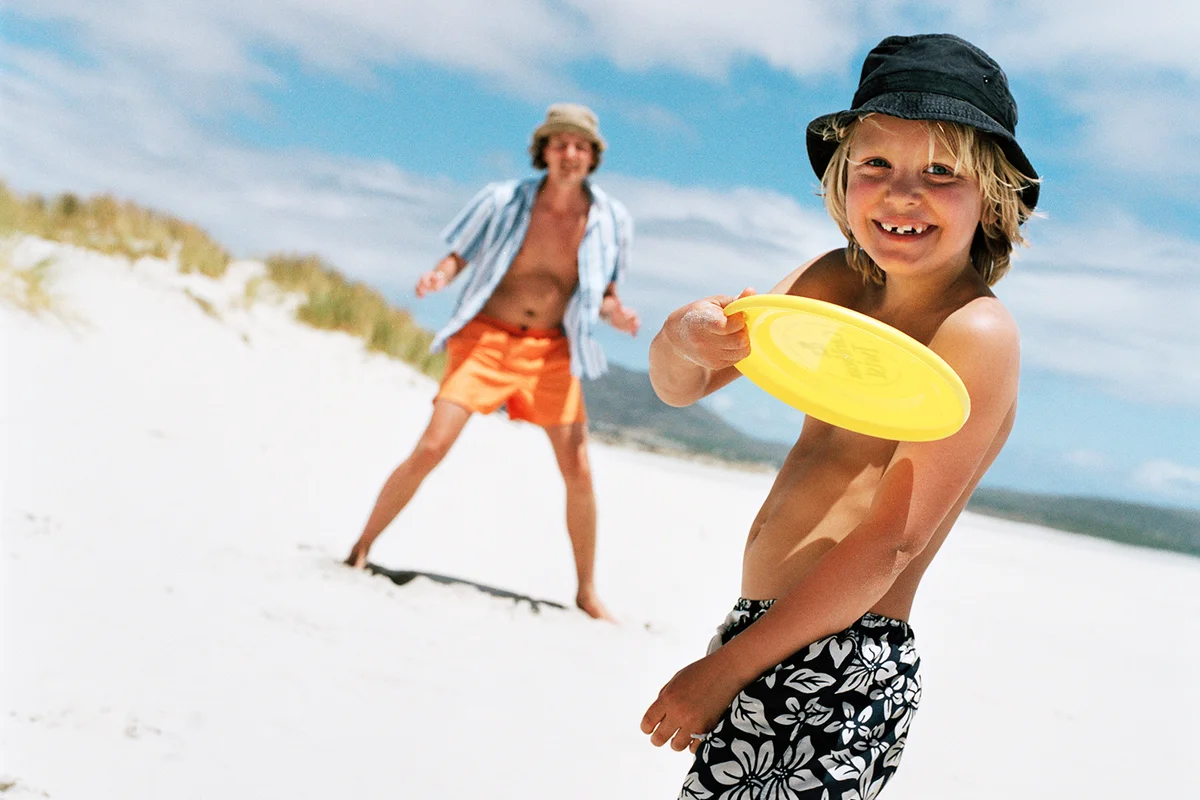 Father and son playing with flying disc