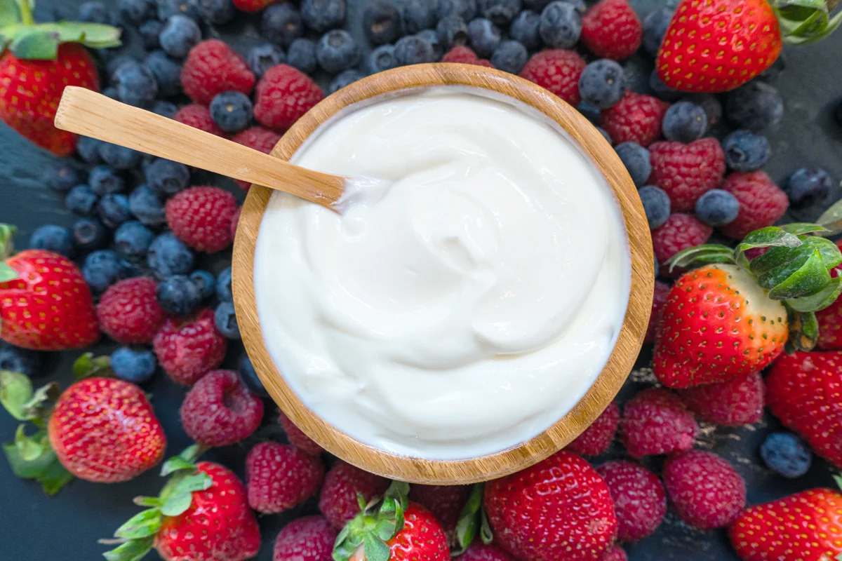 Fresh greek yogurt and berries on background