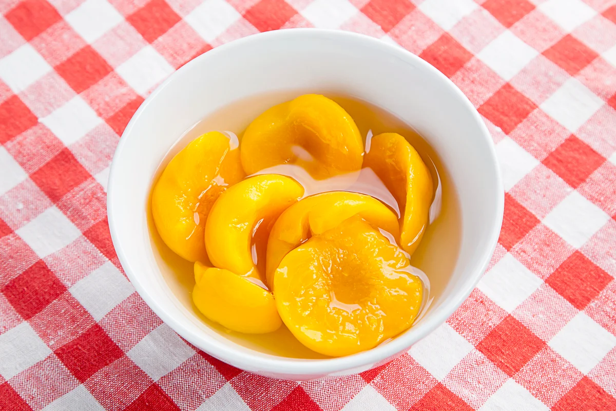 Canned Peaches in white bowl