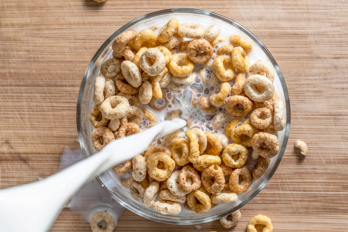 Directly Above Shot Of Milk Pouring In Breakfast Served On Table