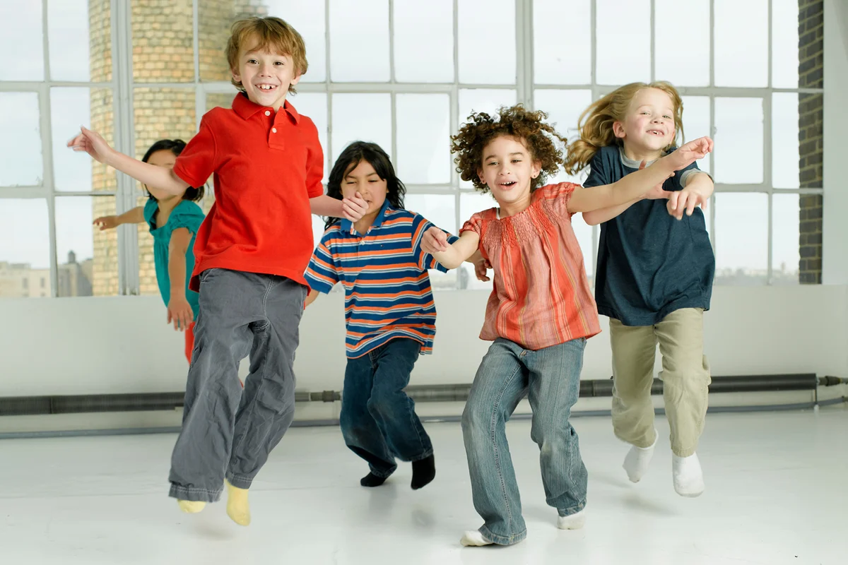 Children jumping, smiling, portrait