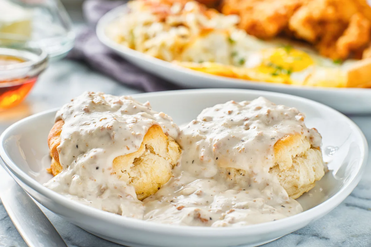 Biscuits and gravy with sausage on plate