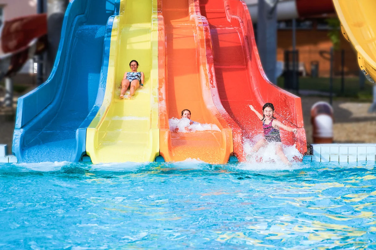 Three girls having fun sliding in a waterpark