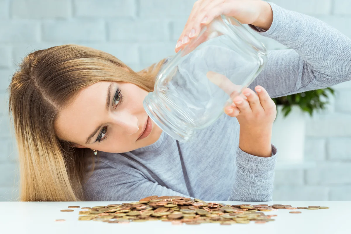 woman emptying change jar