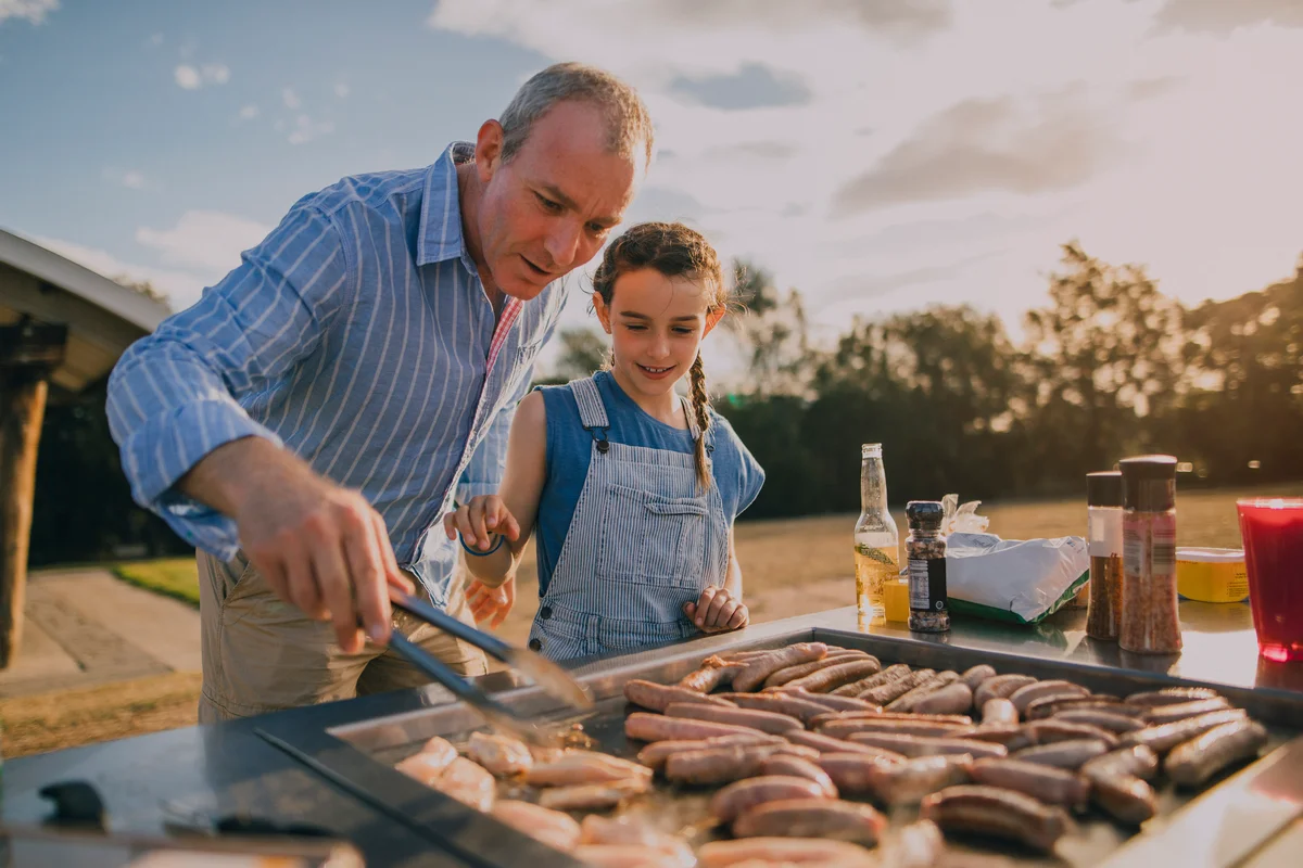 Man grilling with daughter