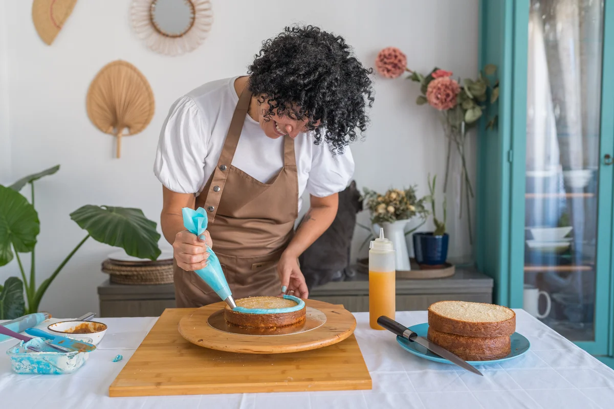 woman decorating a cake