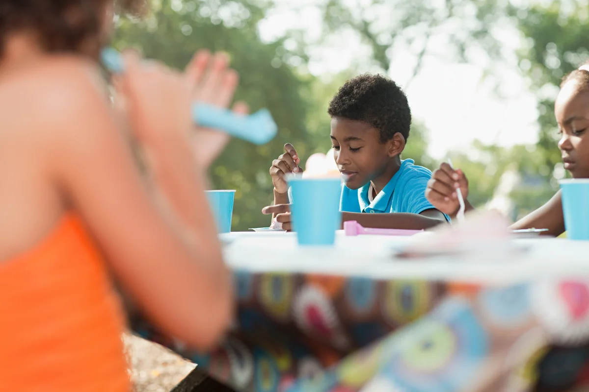 children eating at a picnic table