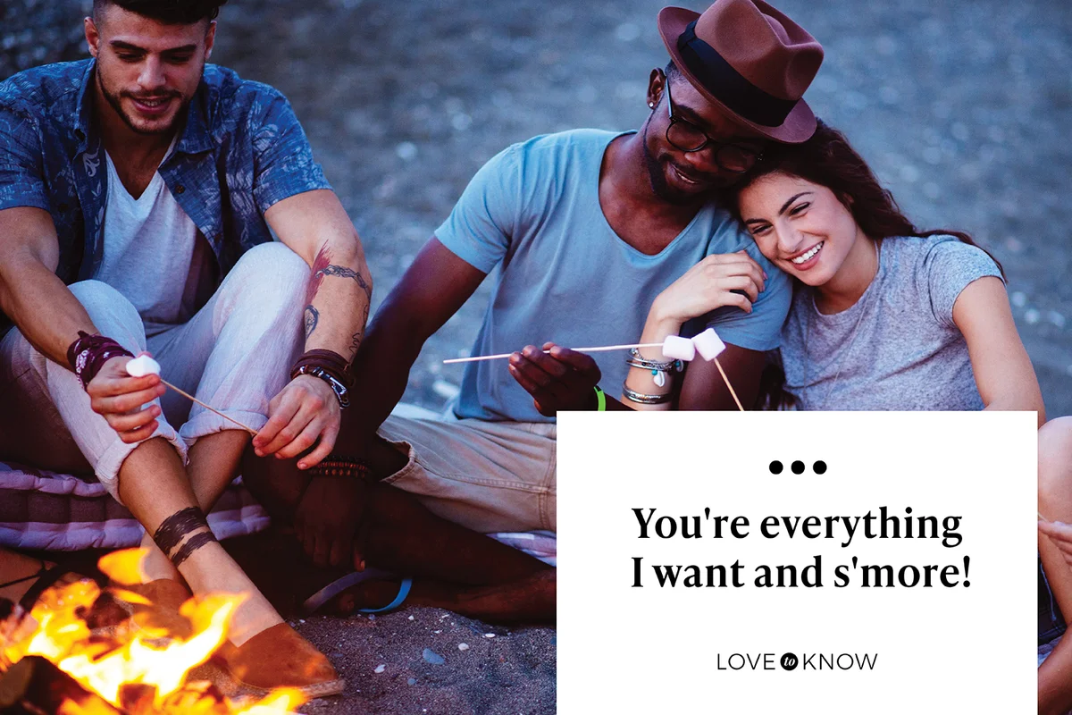 Couple preparing smores on the beach with friends