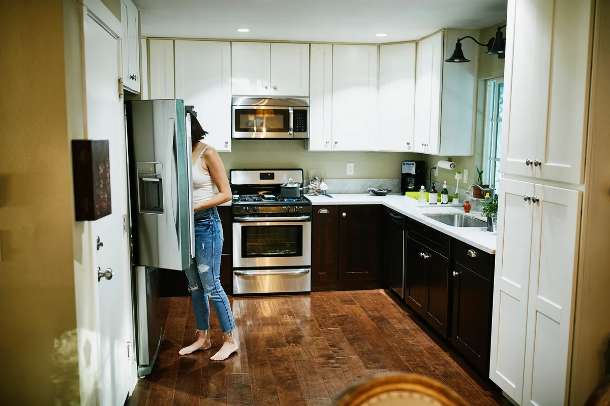 woman looking in fridge