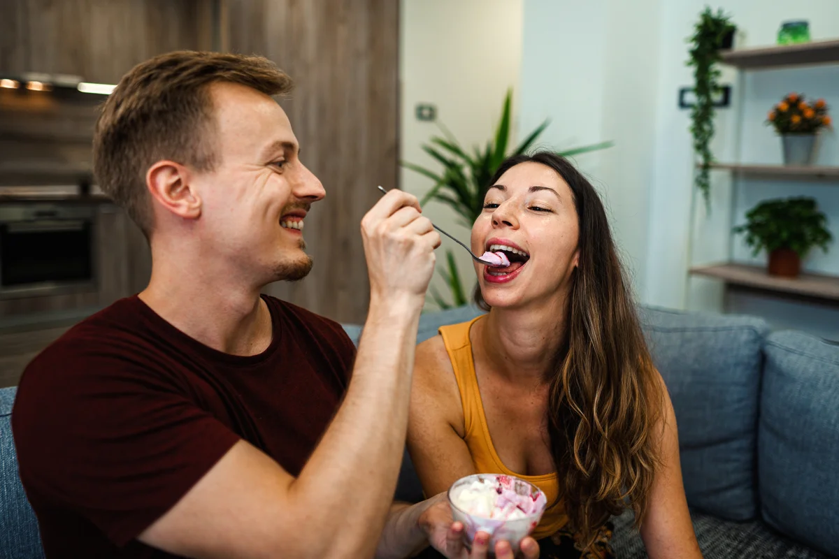 man feeding woman ice cream