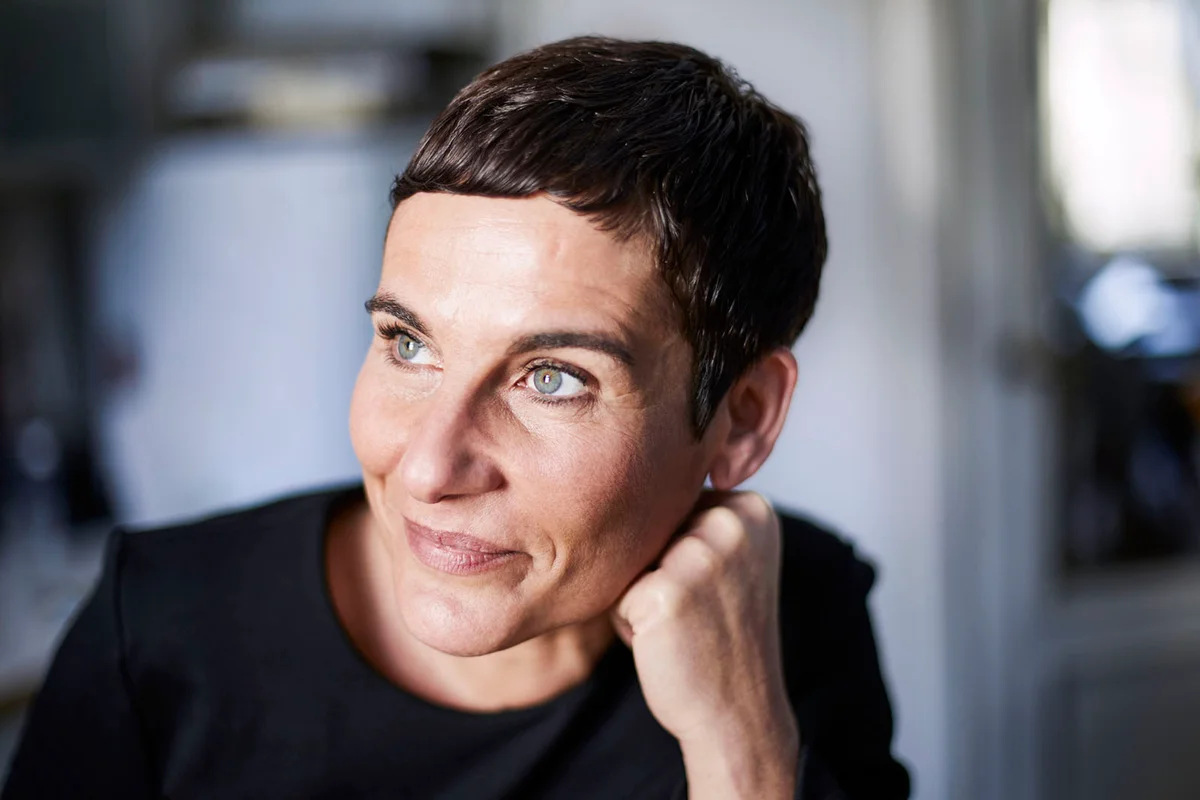 Portrait of smiling short-haired woman at home looking away