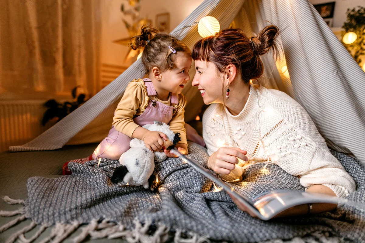 Reading a book under the illuminated tent