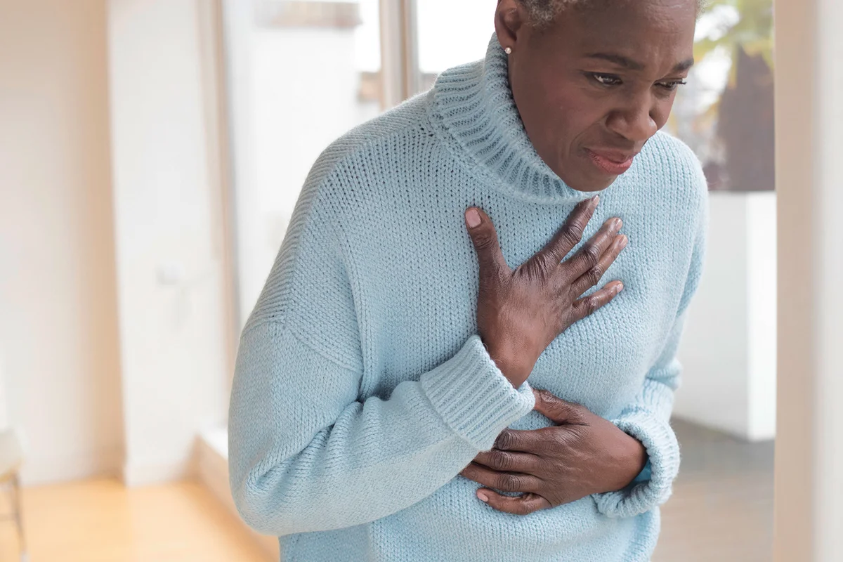 Woman touching chest in pain