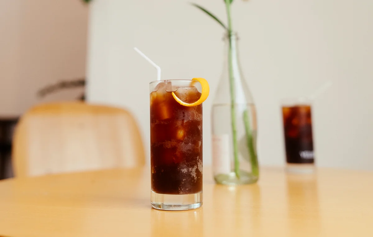 iced coffee with a lemon peel garnish